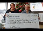 Tomah Health community health educator Julie Anderson, RN, left, presented a ceremonial check to Tomah Neighbor for Neighbor Food Pantry executive director Doug Staller Dec. 17. Contributed photo